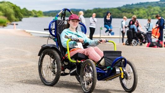 Spinal injury patient on hand bike at SIS BBQ and Activities Day 2019