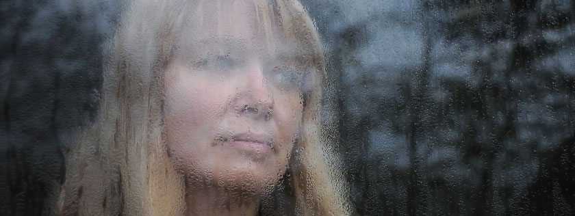 Woman looking out of window