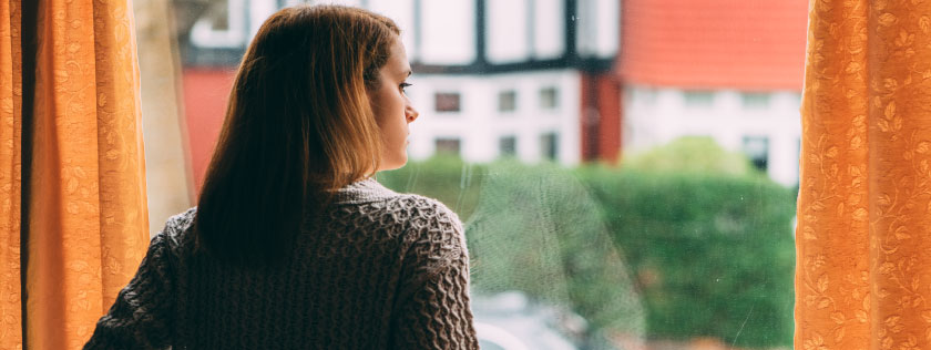 Woman looking out her window