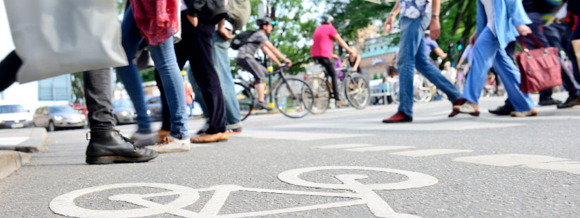 Padestrians crossing road with cyclists in background