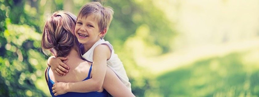 Happy child in mothers arms