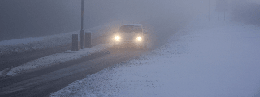 Car driving in the snow and fog
