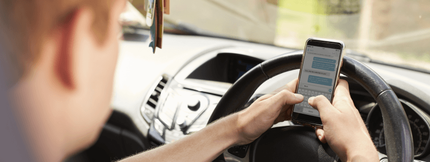 Driver texting on mobile phone whilst driving