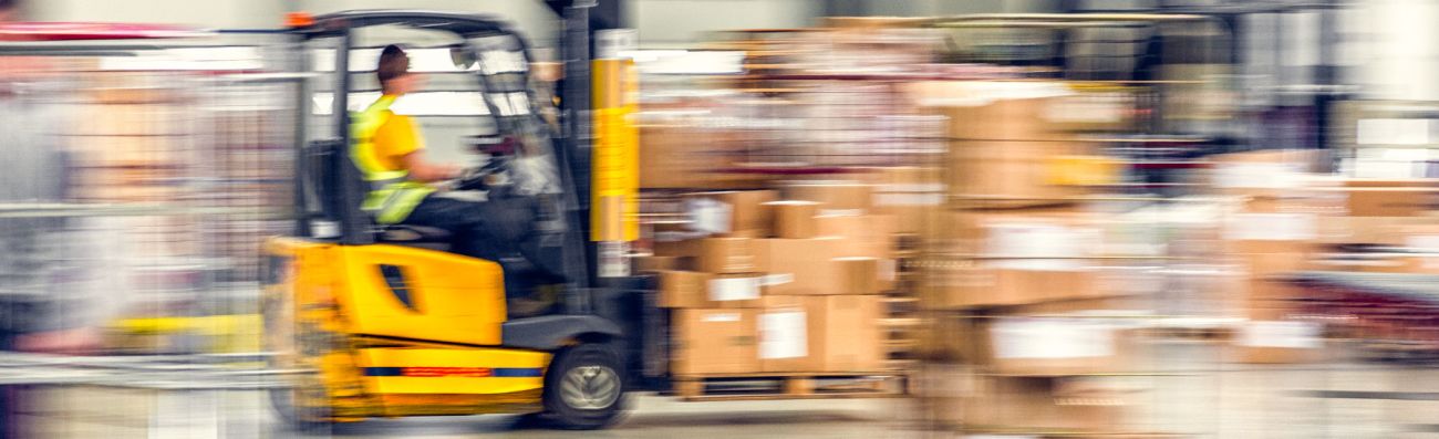 Worker in forklift at a warehouse