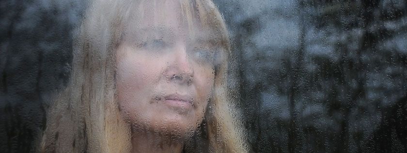 Woman looking out of window
