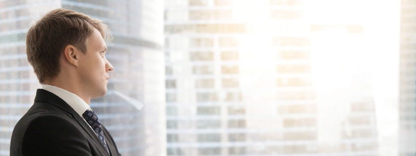 Business man looking out window