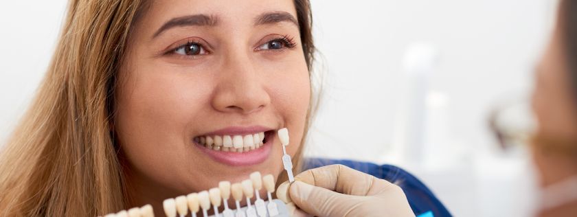 Woman loooking at gettig teeth whitening procedure