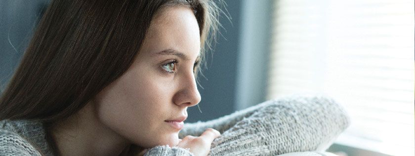 Woman looking out window