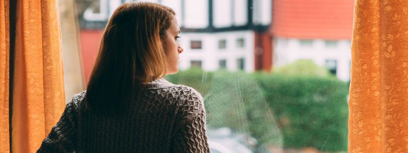 Woman looking out her window