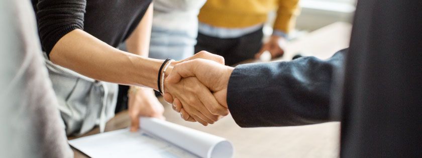 Woman shaking hands with her solicitor