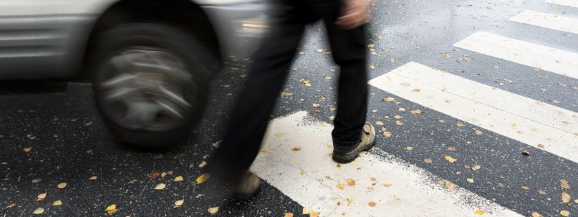 Pedestrian crossing a road at zebra crossing