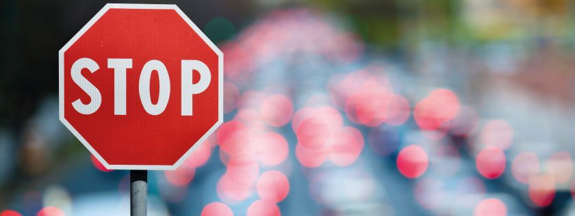 Stop road sign in traffic