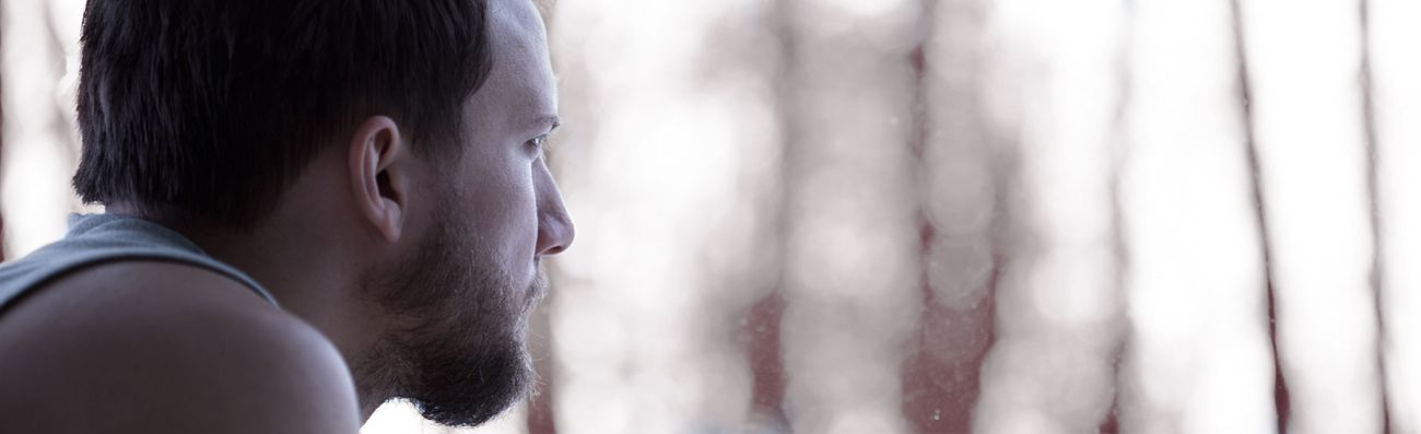 man at window looking out