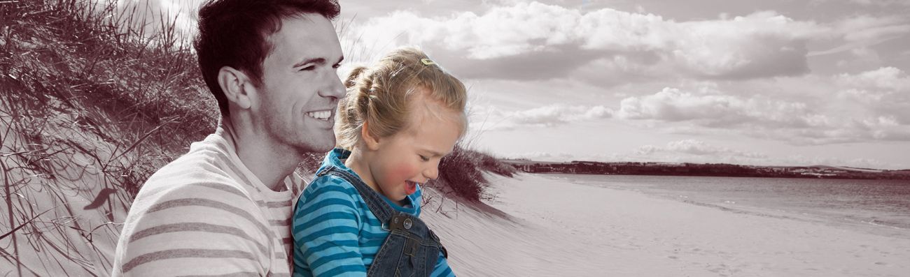 Man with young daughter on the beach