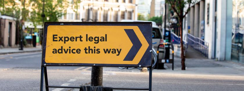 Road sign saying &quot;Expert legal advice this way&quot;
