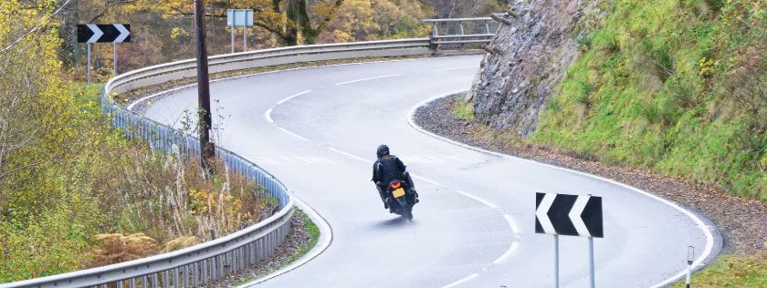 Motorcycle on scottish roads going round bends