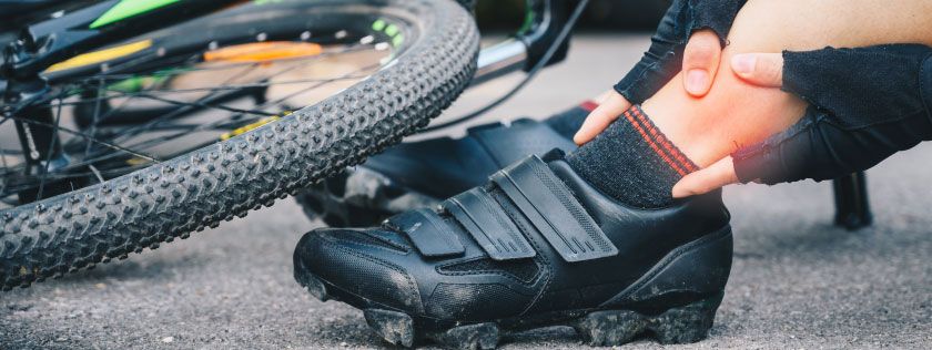 Cyclist sitting in road after being knocked off bike