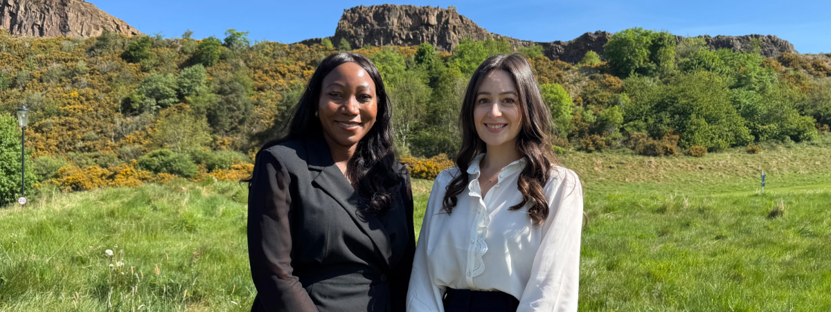 Theresa Mutapi and Rona Hayworth (Digby Brown's newly promoted Partners) standing at the base of Arthur's Seat in Edinburgh