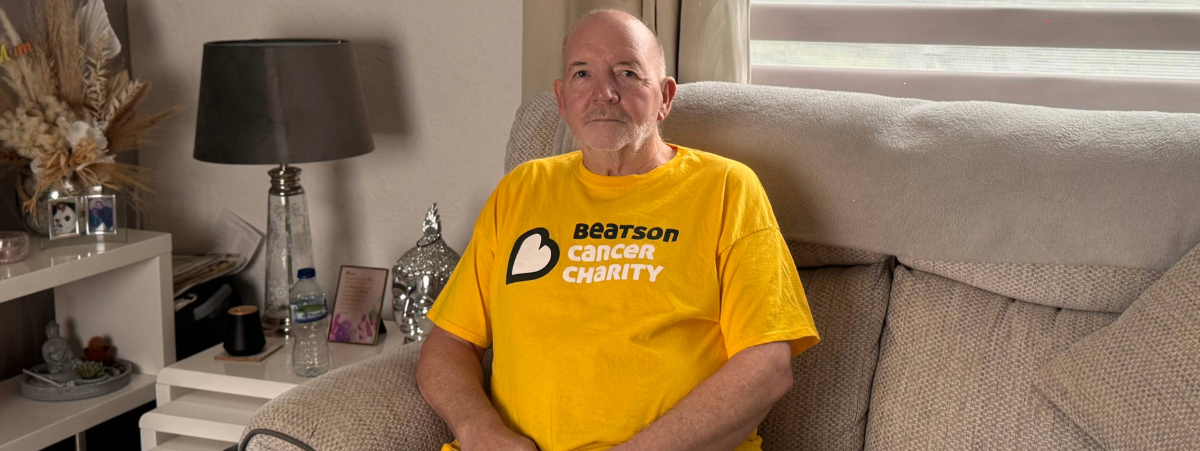 Joe Smith sitting in his home on a couch