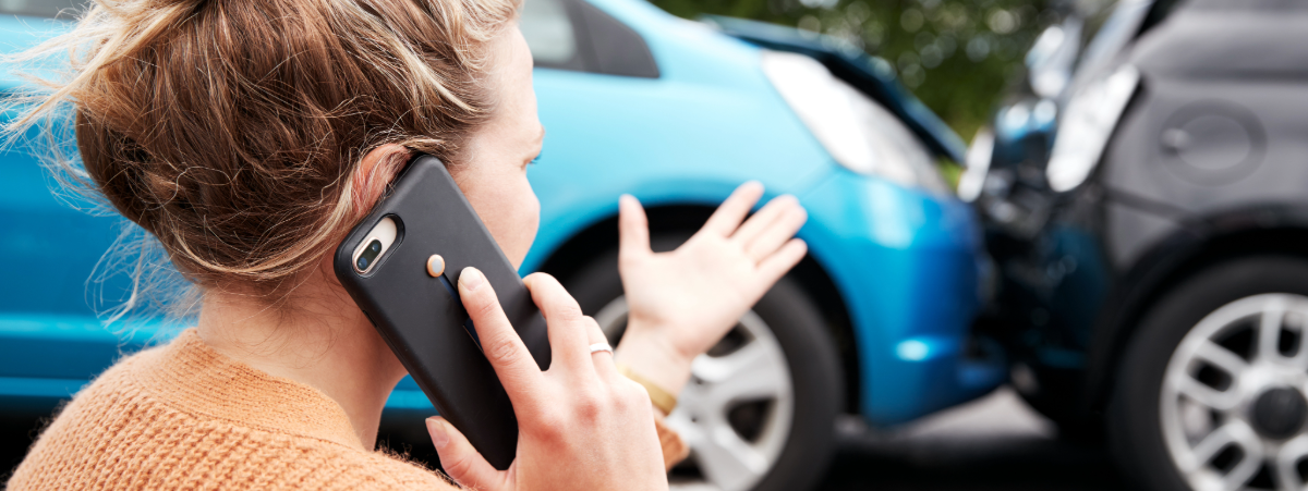 Two cars crashing with driver on the phone to insurance company