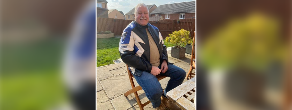 James Cochrane pictured sitting on a chair in a sunny garden