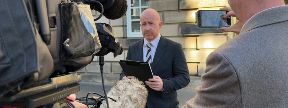 Ryan Smith, Partner in our Kirkcaldy office, pictured reading a statement to media outside the High Court in Edinburgh