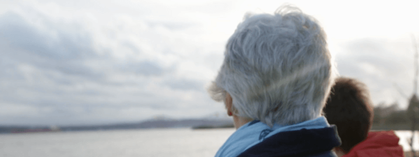 Older woman looking out to sea