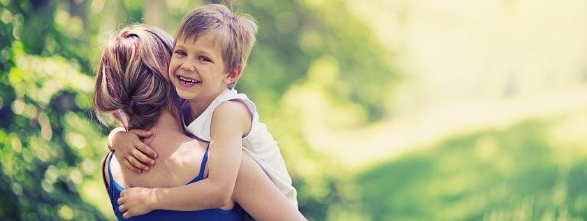 Happy child in mothers arms