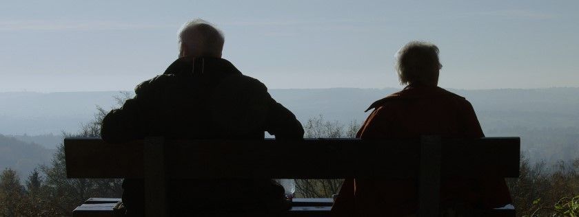 Elderly couple sitting on bench