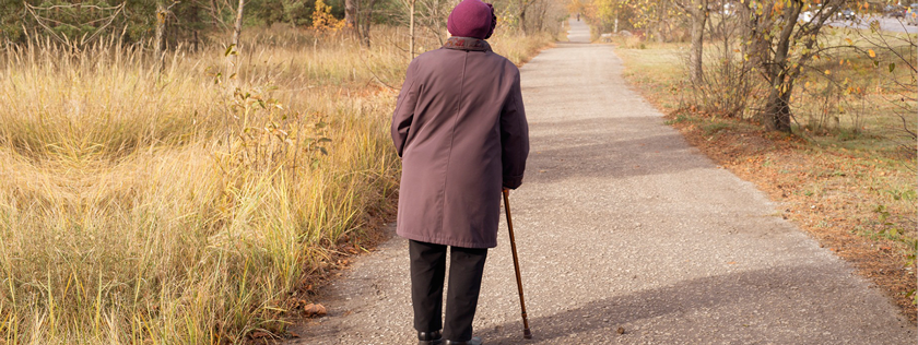 Old woman walking with stick