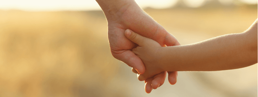 Parent holding childs hand