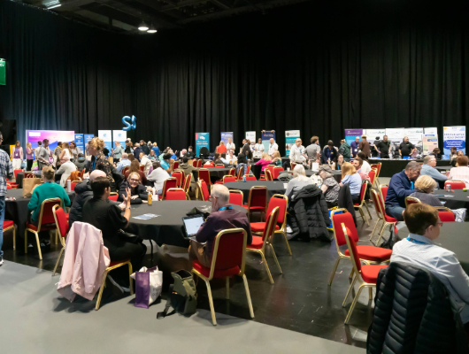 A busy room at the National Head Injury Conference where 48 exhibitor stands are present.