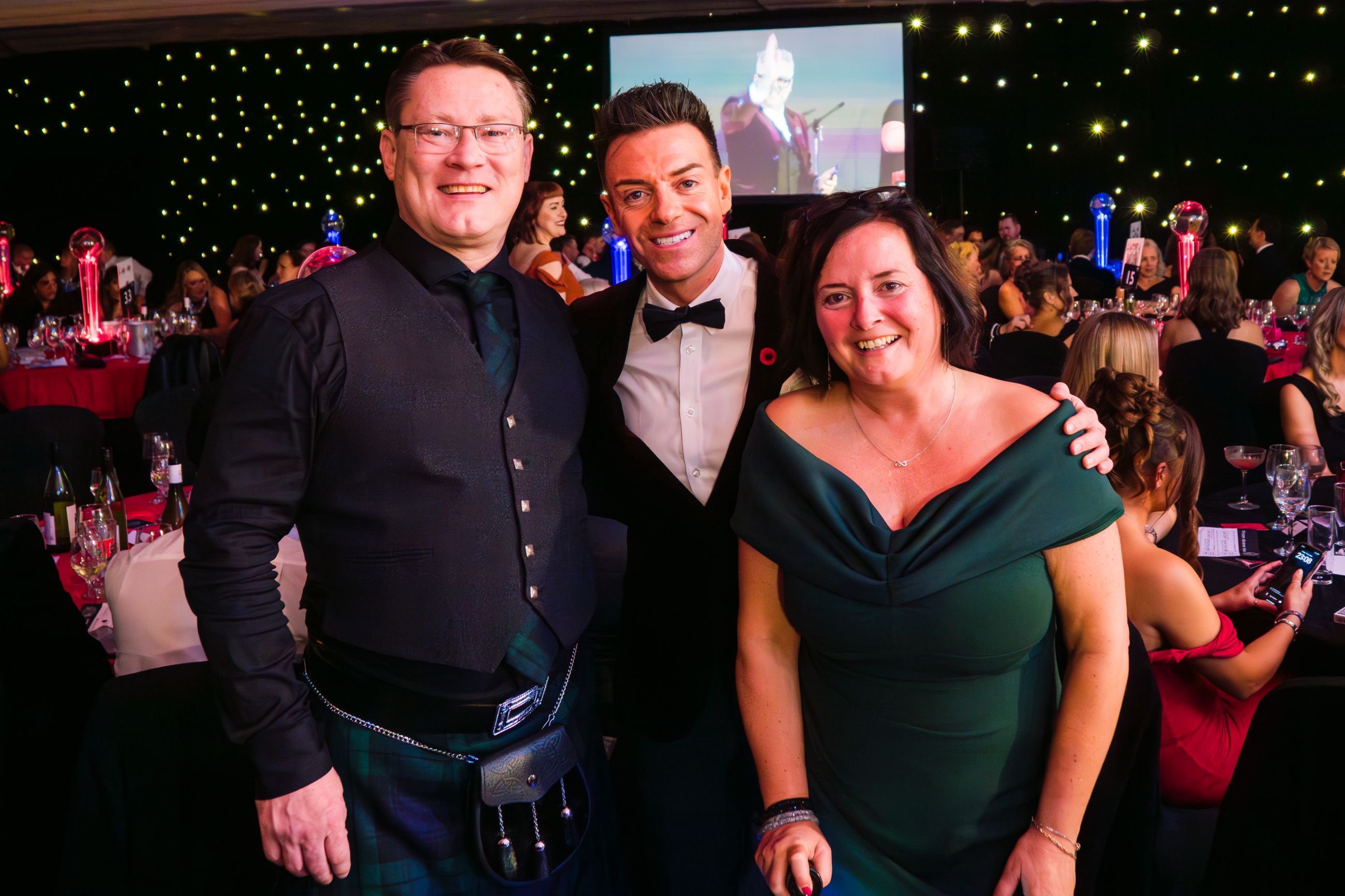 Iain Hamilton with his wife Carron Hamilton and host of the night Des Clarke