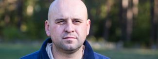 Man looking to camera in park