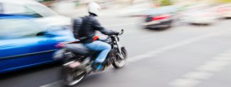 Motorcycle in traffic in town