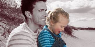 Man with young daughter on the beach