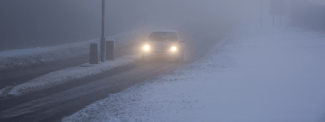 Car driving in the snow and fog