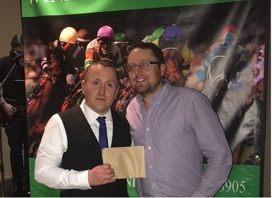 David McGowan presents one of the winners prizes at the race night for Headway Highland