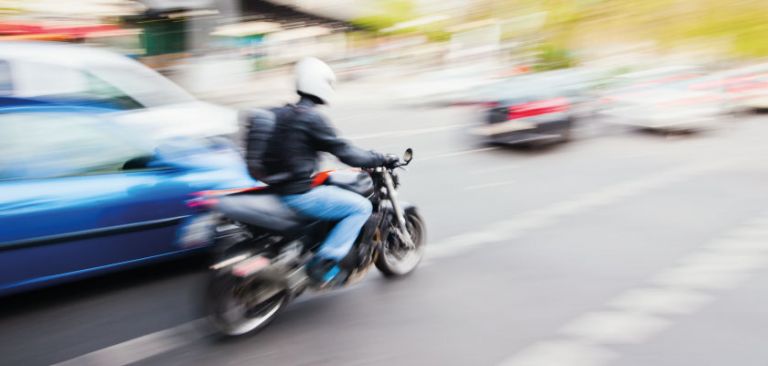 Motorbike in town traffic
