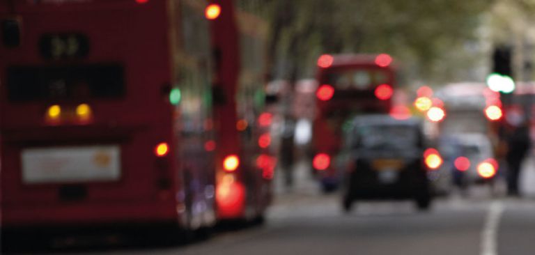 Buses and taxi in town traffic