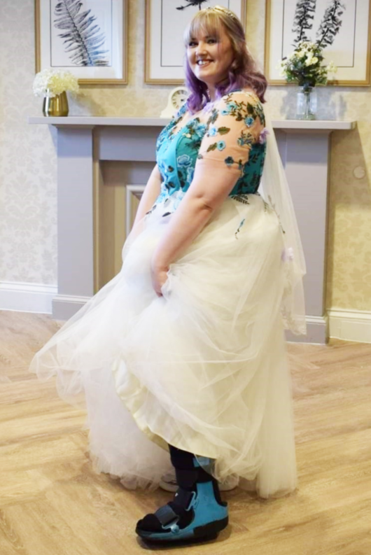 Our client Laura Laing showing her moon boot while in her wedding dress.