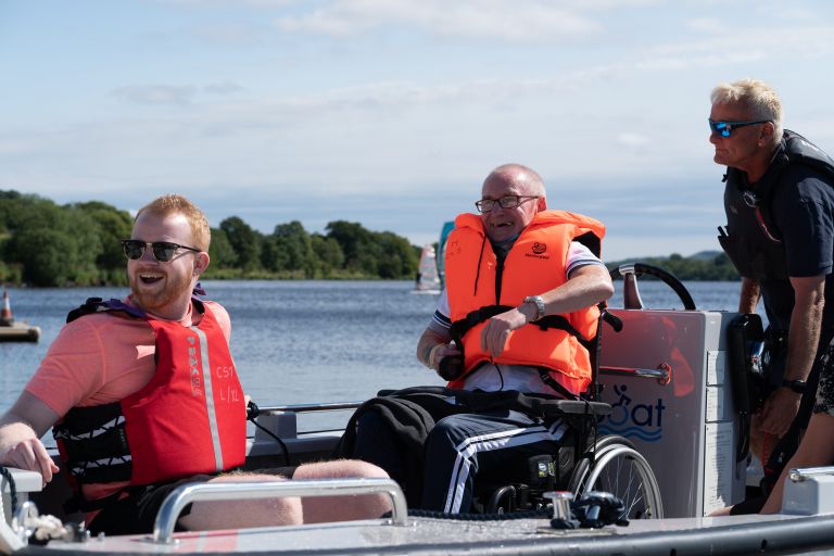 Men sailing on adapted powerboat