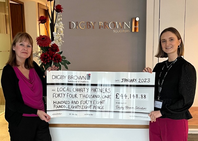 Large Digby Brown cheque with final total raised by staff for 2022 local charity partners.