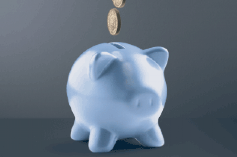 Piggby bank with money going into it