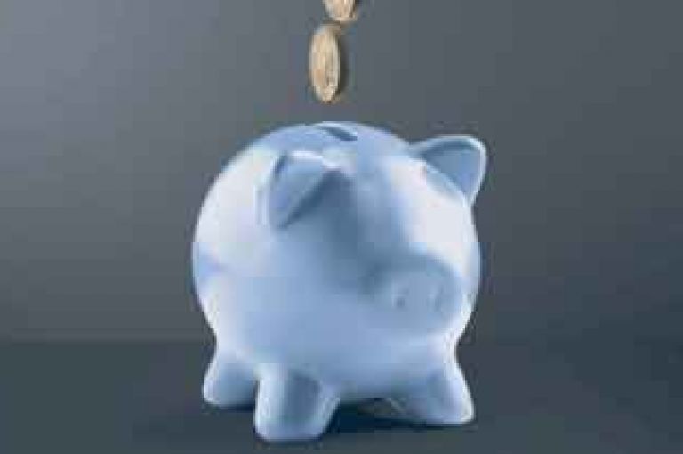 Piggby bank with money going into it