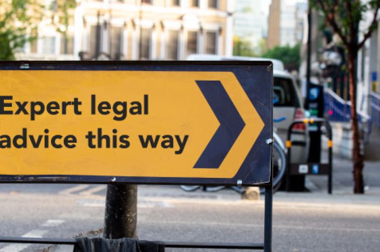 Road sign saying "Expert legal advice this way"