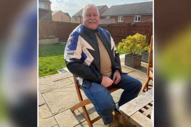 James Cochrane pictured sitting on a chair in a sunny garden