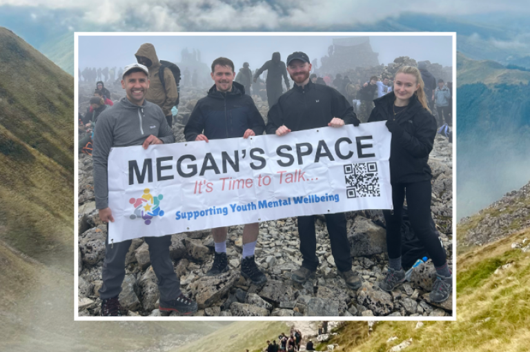 Four colleagues from our Ayr office pictured at the summit of Ben Nevis holding a banner for their local office charity Megan's Space