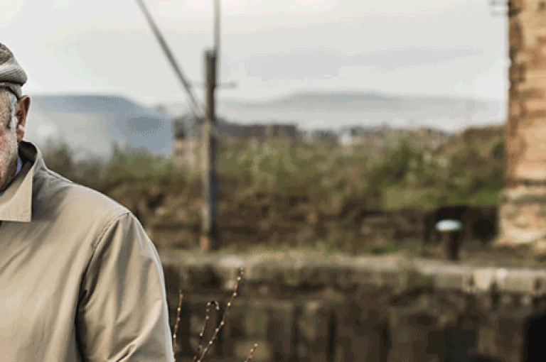 Older man looking to camera