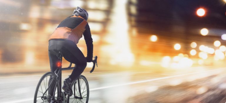 Cyclist on road at night